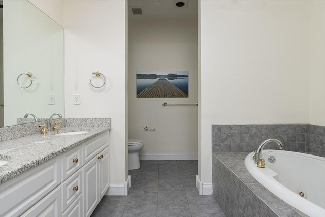 bathroom with tile patterned flooring, vanity, a relaxing tiled tub, and toilet