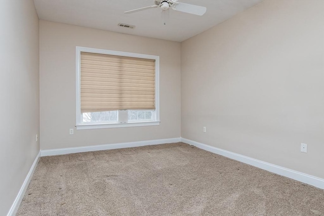 spare room featuring carpet floors and ceiling fan