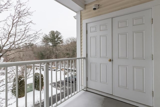 view of snow covered back of property