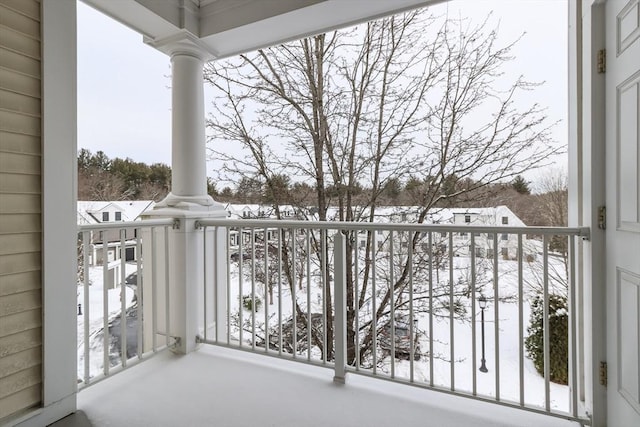 view of snow covered back of property