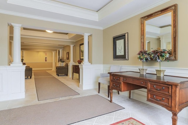 interior space with ornamental molding, a tray ceiling, decorative columns, and light tile patterned floors