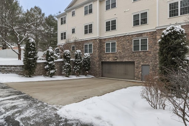 snow covered building with a garage