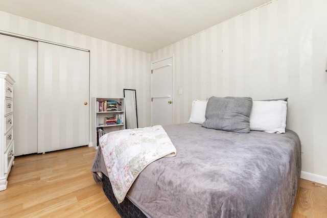 bedroom featuring light wood-type flooring and a closet