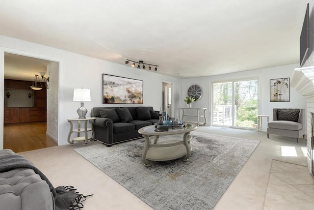living room featuring rail lighting and light colored carpet