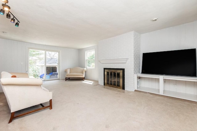 carpeted living area with a fireplace