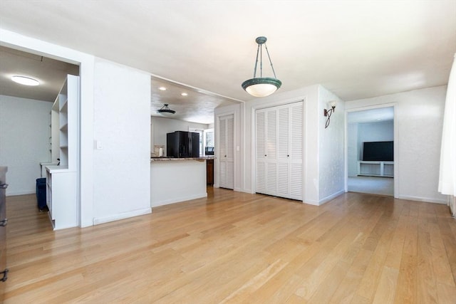 unfurnished living room with light wood-style floors, baseboards, and recessed lighting