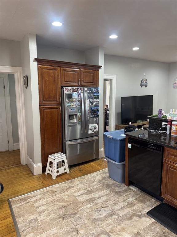 kitchen featuring stainless steel refrigerator with ice dispenser, dark countertops, recessed lighting, light wood-style floors, and dishwasher