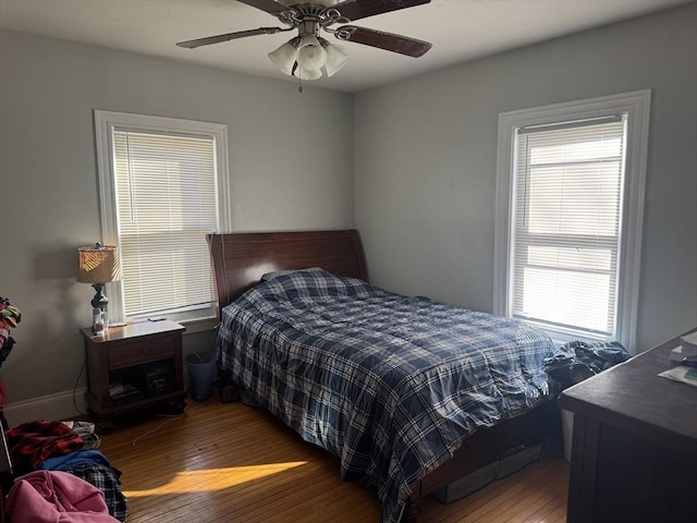 bedroom with hardwood / wood-style floors and ceiling fan