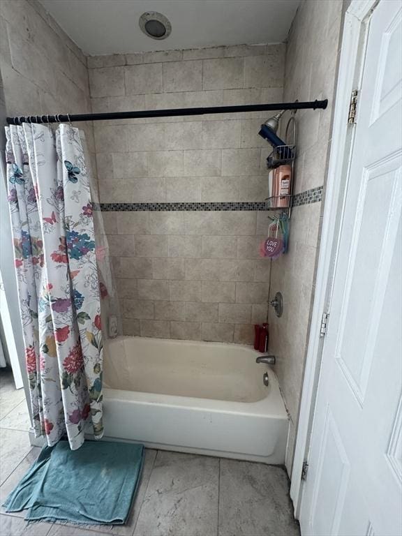 bathroom featuring tile patterned flooring and shower / tub combo