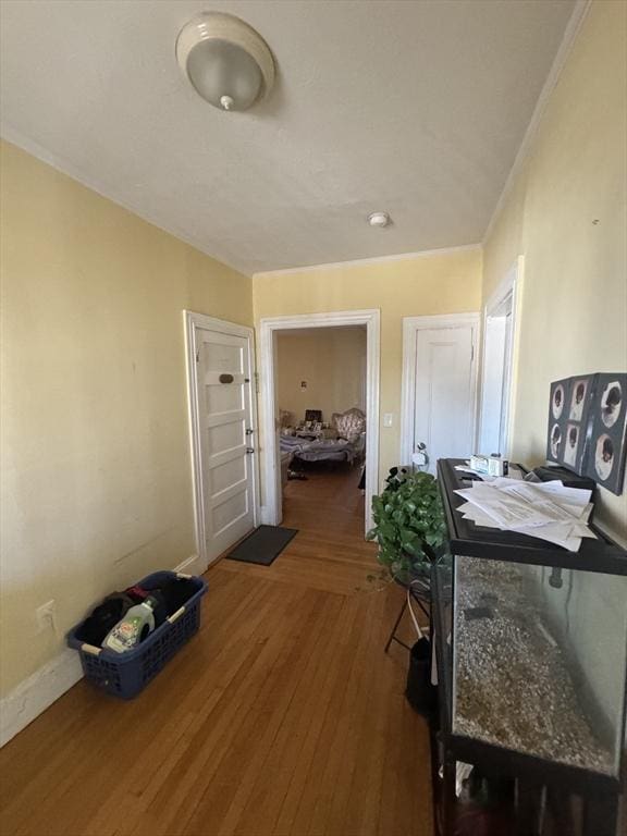 hallway featuring baseboards and wood finished floors