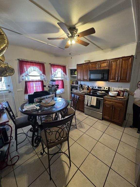 kitchen featuring stainless steel range with electric stovetop, plenty of natural light, black microwave, and ceiling fan