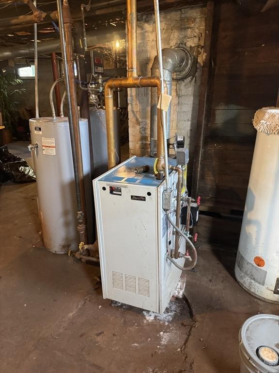 utility room featuring gas water heater and a heating unit