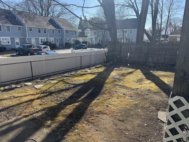 view of yard featuring a residential view and fence