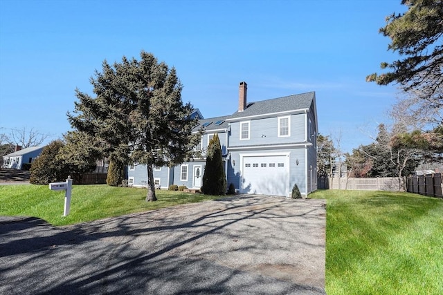 front facade with a garage and a front yard