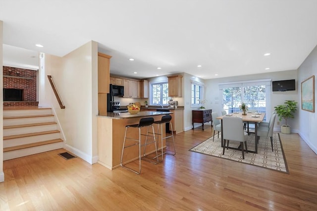 dining space with light hardwood / wood-style flooring