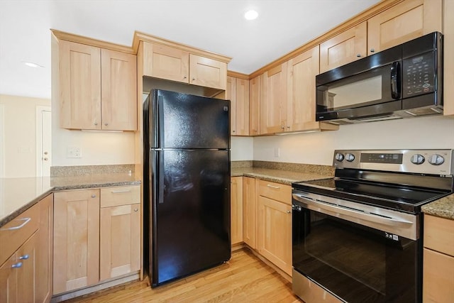 kitchen featuring light stone countertops, black appliances, light hardwood / wood-style floors, and light brown cabinets