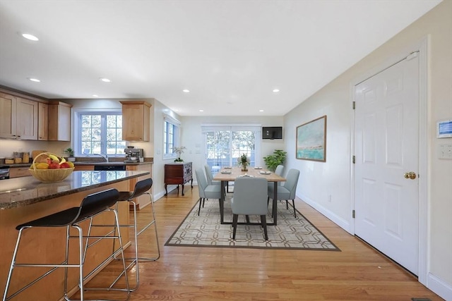 dining area with plenty of natural light and light hardwood / wood-style floors