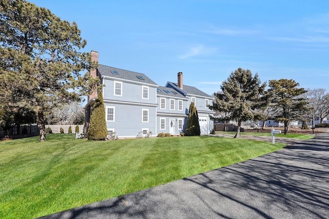 rear view of house featuring a yard