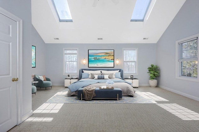 carpeted bedroom with high vaulted ceiling and a skylight