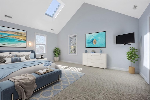 carpeted bedroom with a skylight and high vaulted ceiling