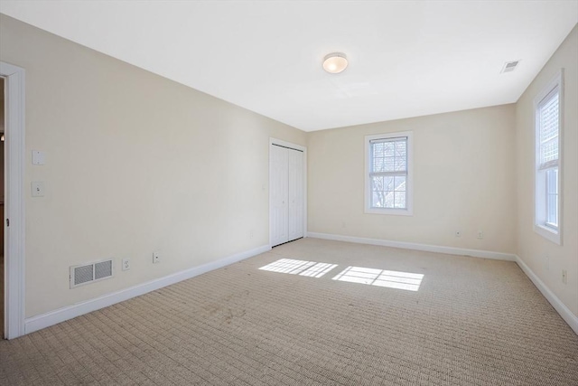 spare room with light colored carpet