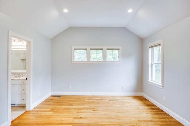 15 Hydrangea Cir, Falmouth, MA 02536 - spare room with healthy amount of natural light, light wood finished floors, baseboards, vaulted ceiling, and recessed lighting