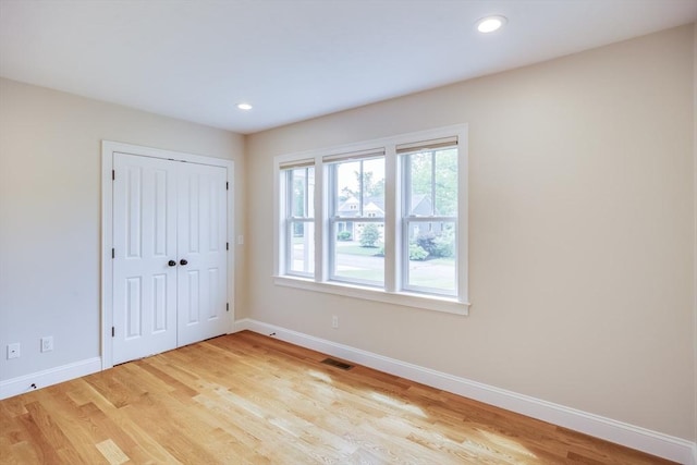 15 Hydrangea Cir, Falmouth, MA 02536 - unfurnished bedroom featuring baseboards, multiple windows, wood finished floors, and recessed lighting