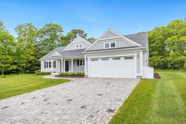15 Hydrangea Cir, Falmouth, MA 02536 - shingle-style home featuring decorative driveway, an attached garage, a front yard, and covered porch