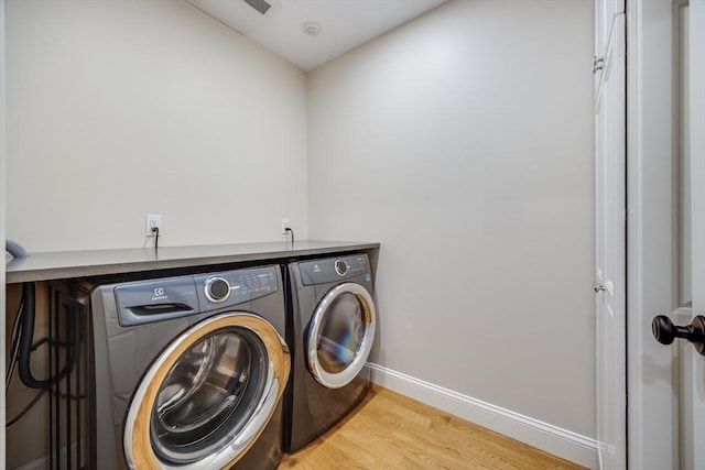15 Hydrangea Cir, Falmouth, MA 02536 - laundry room featuring washer and clothes dryer, light wood finished floors, and baseboards