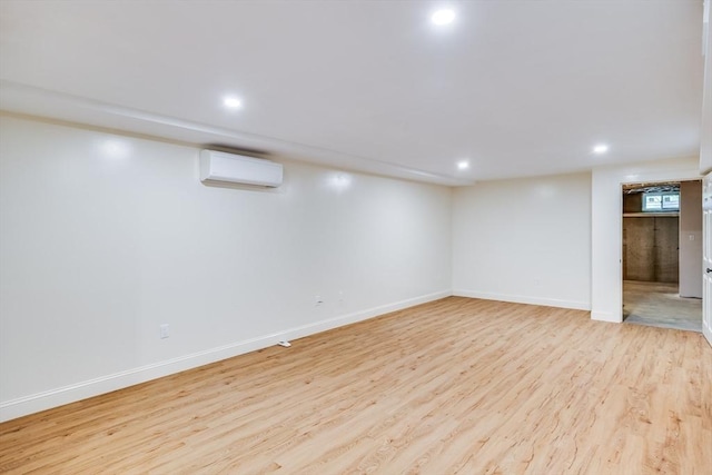 15 Hydrangea Cir, Falmouth, MA 02536 - below grade area featuring an AC wall unit, light wood-style floors, recessed lighting, and baseboards