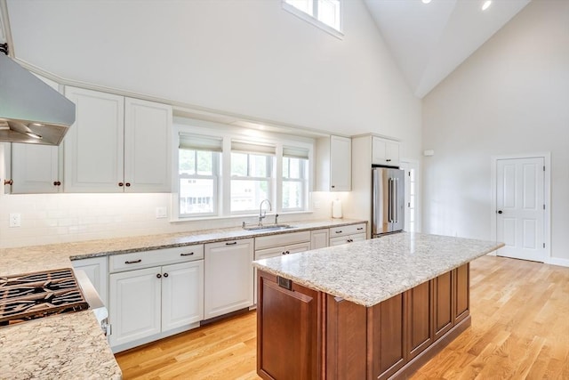 15 Hydrangea Cir, Falmouth, MA 02536 - kitchen featuring wall chimney range hood, a sink, high end refrigerator, light wood-style flooring, and high vaulted ceiling
