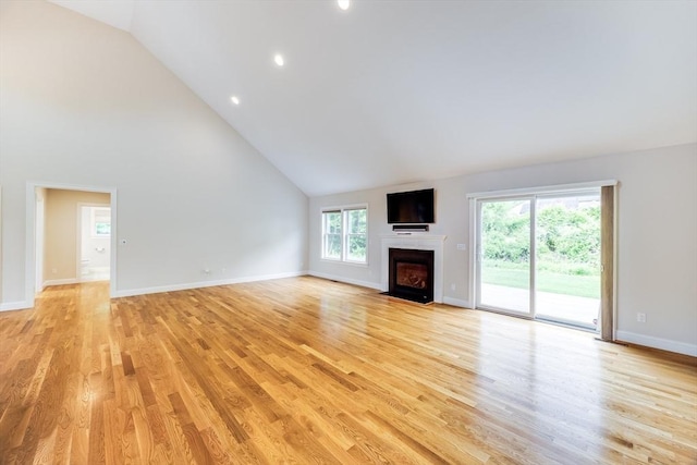 15 Hydrangea Cir, Falmouth, MA 02536 - unfurnished living room with a fireplace with flush hearth, light wood-style floors, high vaulted ceiling, baseboards, and recessed lighting