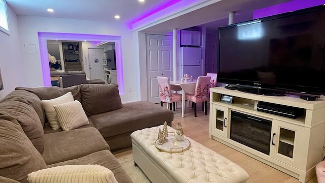 living area with light wood finished floors and recessed lighting