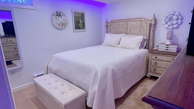 bedroom with baseboards and wood finished floors