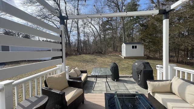 deck featuring a grill, outdoor lounge area, a storage shed, and an outdoor structure