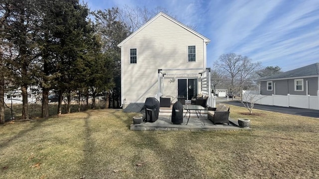 rear view of house featuring an outdoor hangout area, a lawn, fence, and a patio