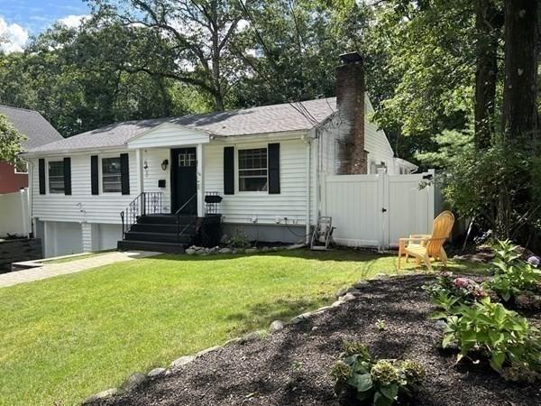 view of front of home with a garage and a front lawn