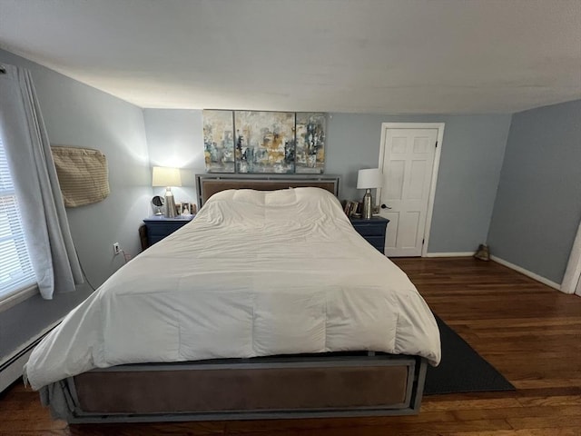 bedroom with dark hardwood / wood-style flooring