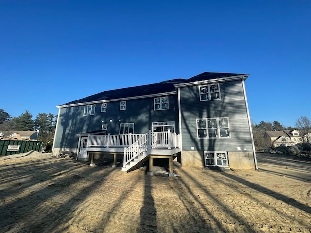 rear view of property with a wooden deck