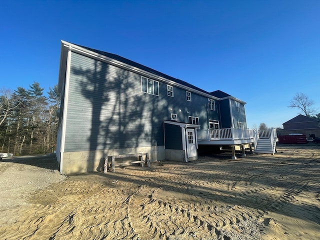 back of house featuring a deck