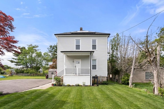 13 Darling St, Acushnet, MA 02743 - rear view of house featuring solar panels, a lawn, and a chimney