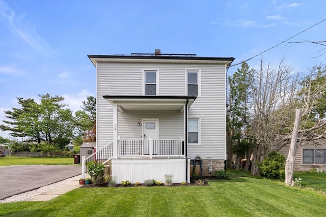 13 Darling St, Acushnet, MA 02743 - american foursquare style home with a front yard, covered porch, and roof mounted solar panels