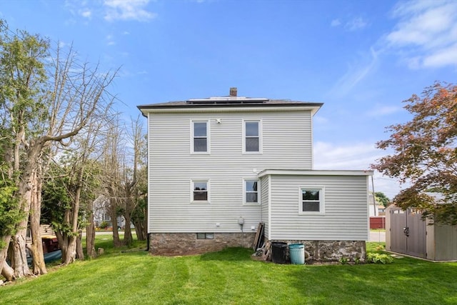 13 Darling St, Acushnet, MA 02743 - back of house with solar panels, a lawn, and a chimney
