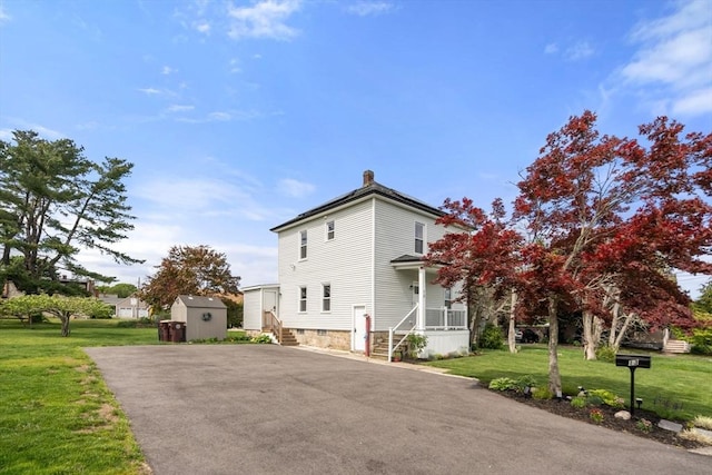13 Darling St, Acushnet, MA 02743 - view of side of property featuring a chimney, driveway, a yard, and a porch
