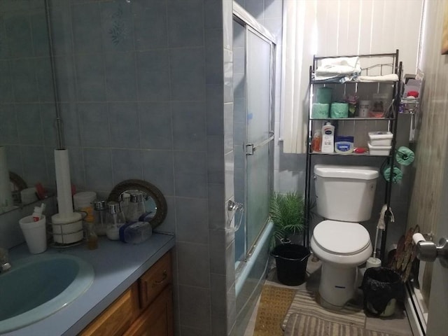 1166 Douglas Ave, North Providence, RI 02904 - bathroom with toilet, vanity, shower / bath combination with glass door, and tile walls