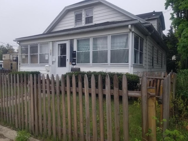 1166 Douglas Ave, North Providence, RI 02904 - view of front of property with a sunroom and fence