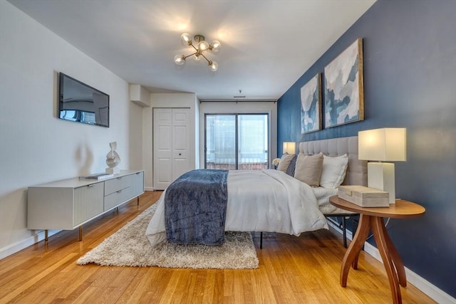 bedroom with light wood-type flooring and baseboards