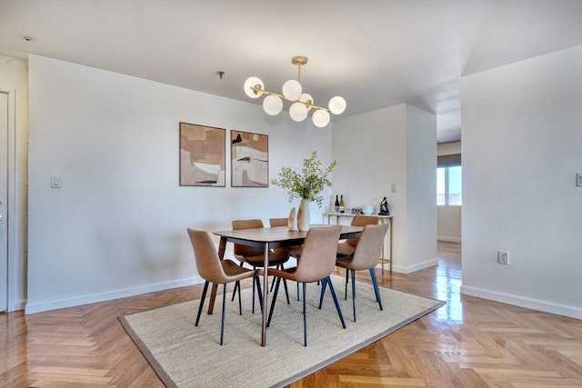 dining area with baseboards and a notable chandelier