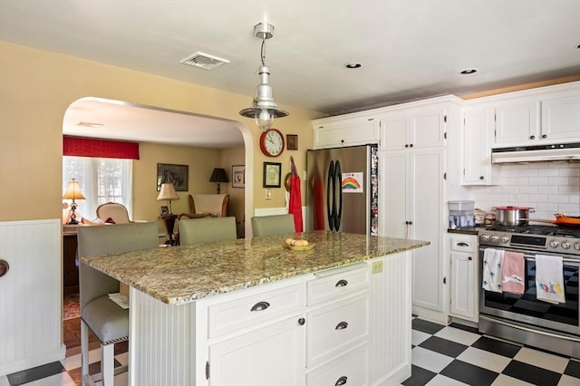 63 Hawthorne, Weymouth, MA 02189 - kitchen with stainless steel appliances, arched walkways, under cabinet range hood, tile patterned floors, and white cabinets