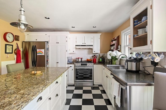 63 Hawthorne, Weymouth, MA 02189 - kitchen featuring appliances with stainless steel finishes, a sink, under cabinet range hood, dark floors, and backsplash